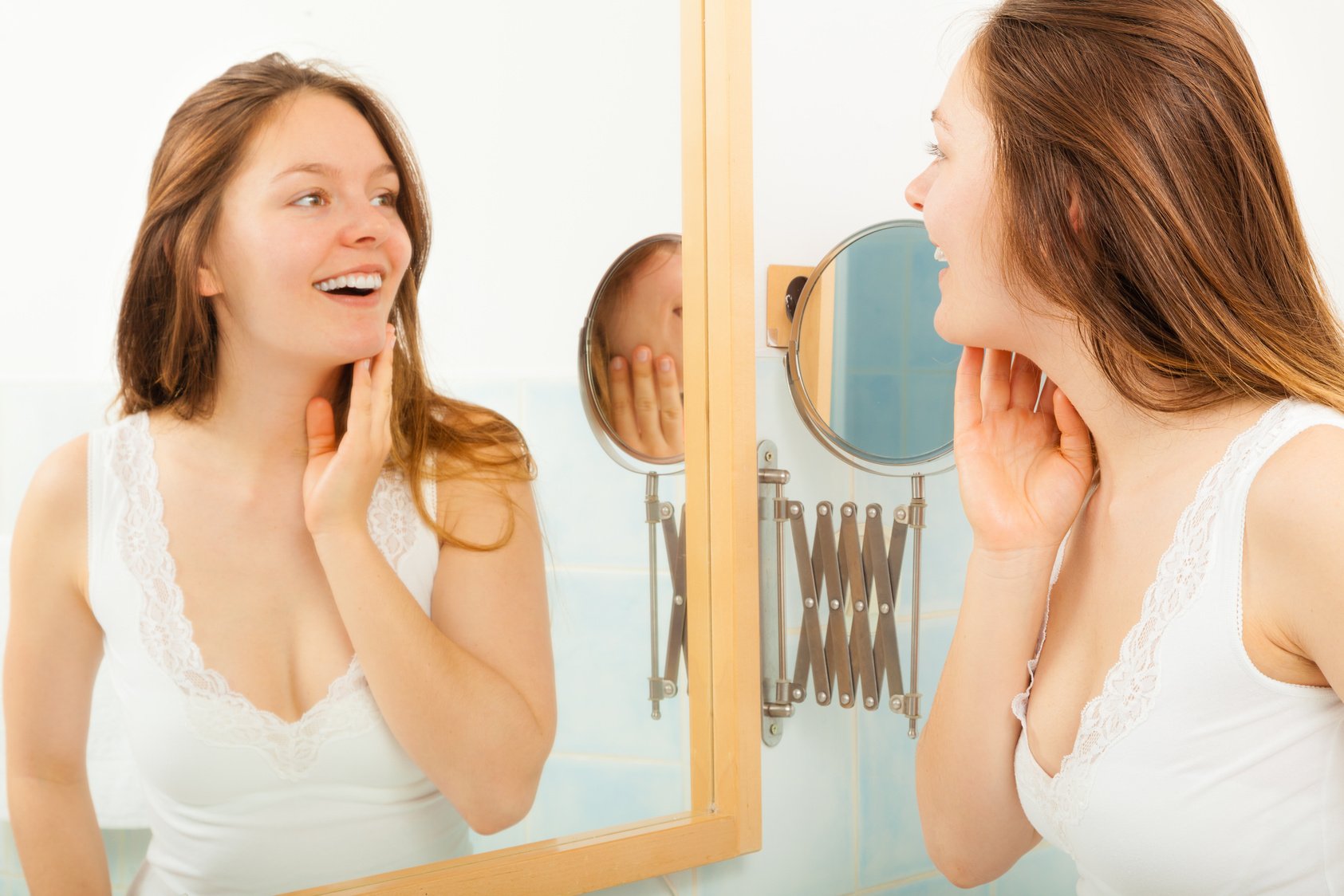 Woman without makeup in bathroom.