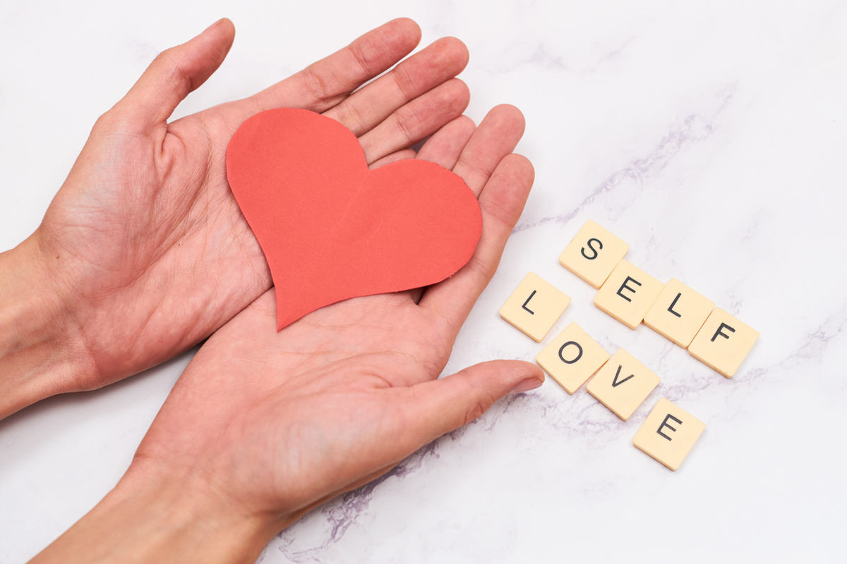 Alphabet blocks with the word self love.